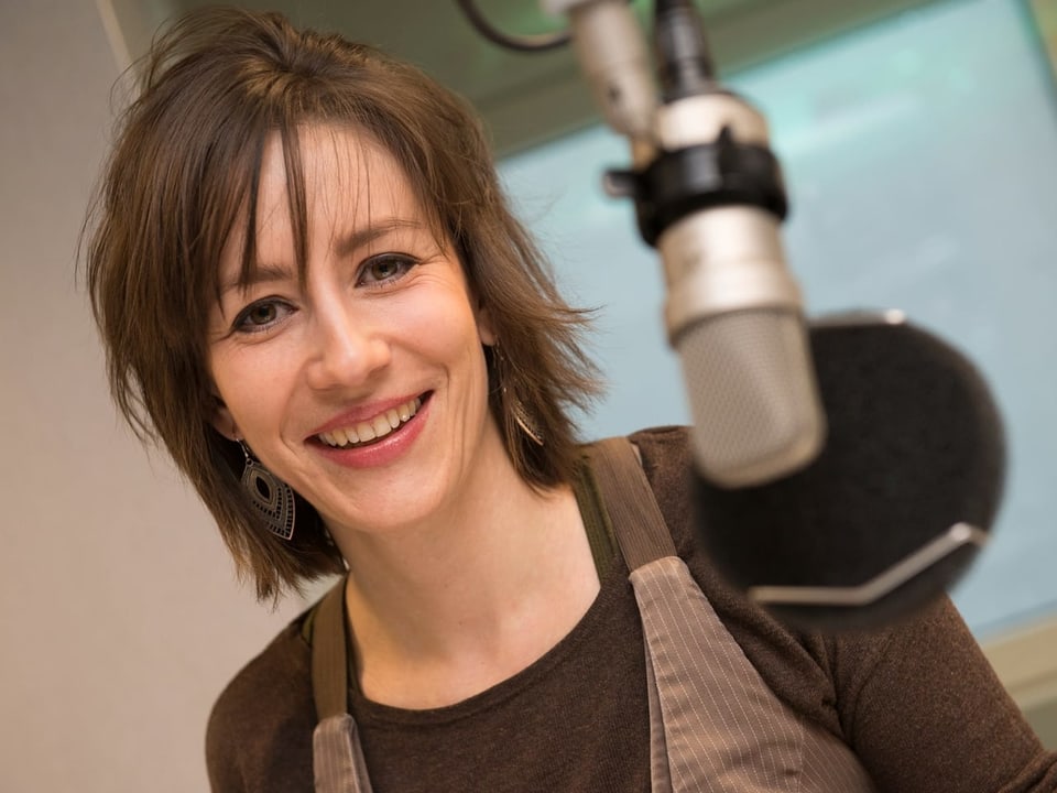 Das Bild zeigt eine Frau in einem Radiostudio.