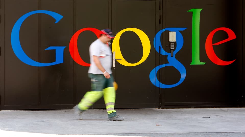 Ein Bauarbeiter vor einem Google-Schriftzug.