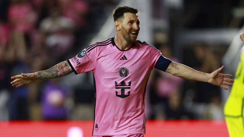 Lionel Messi auf dem Fussballfeld mit pinkem Trikot.
