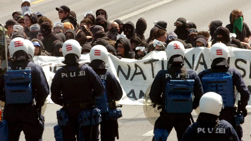 Demonstranten und Polizisten stehen sich auf der Luzerner Seebrücke gegenüber.