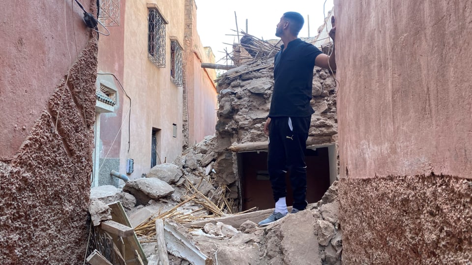 Ein Mann steht inmitten von Trümmern in Marrakesch.