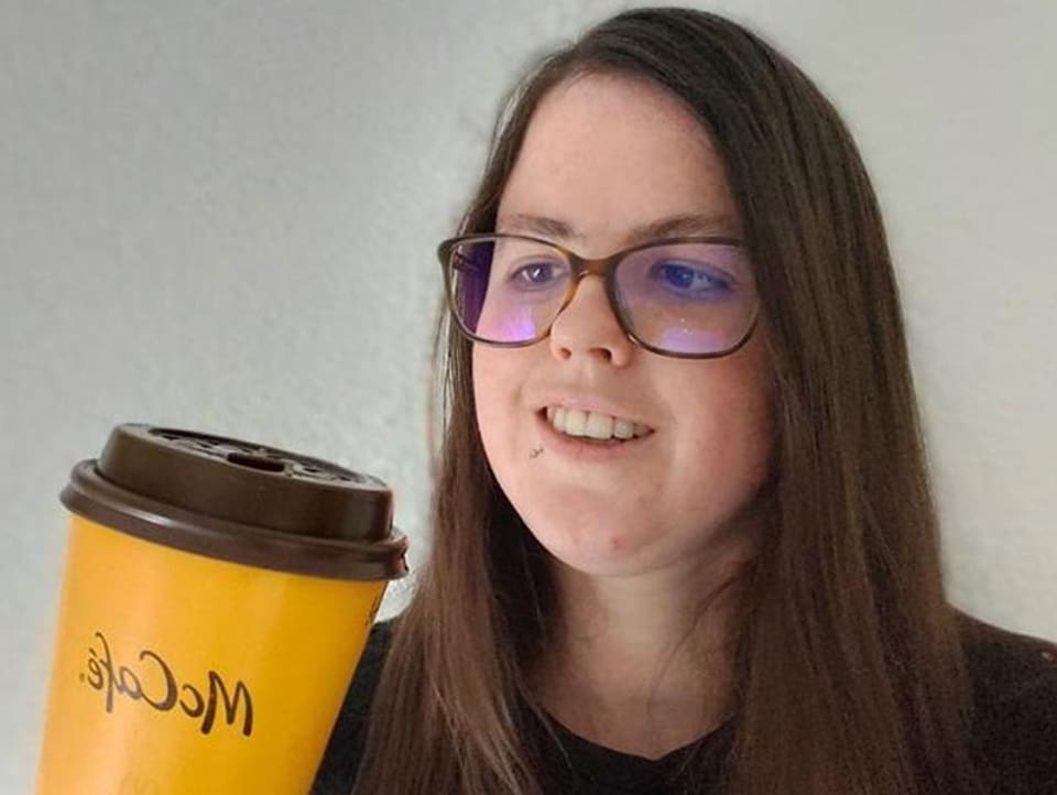 Vanessa Lehmann betrachtet einen Cappuccino-Becher von McDonalds