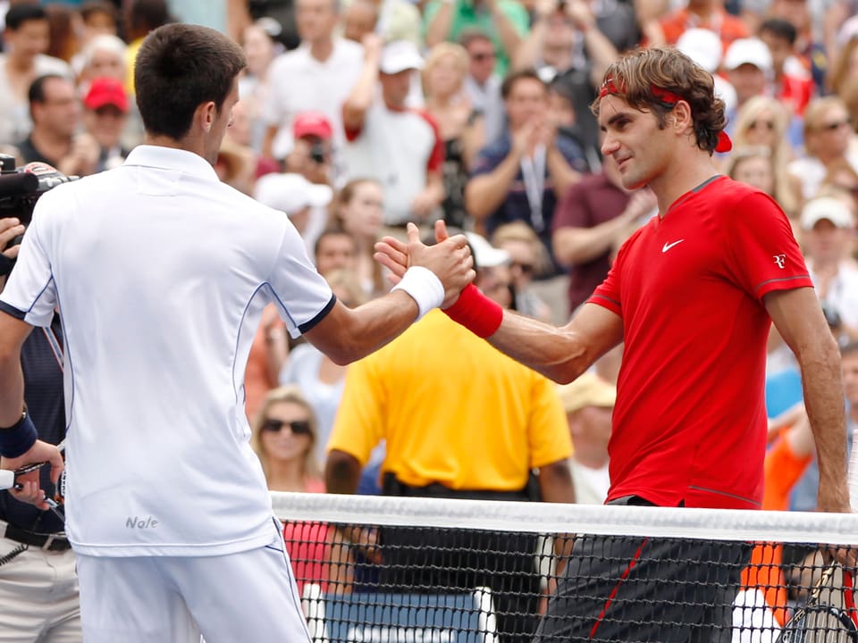 Federer und Djokovic geben sich die Hände.