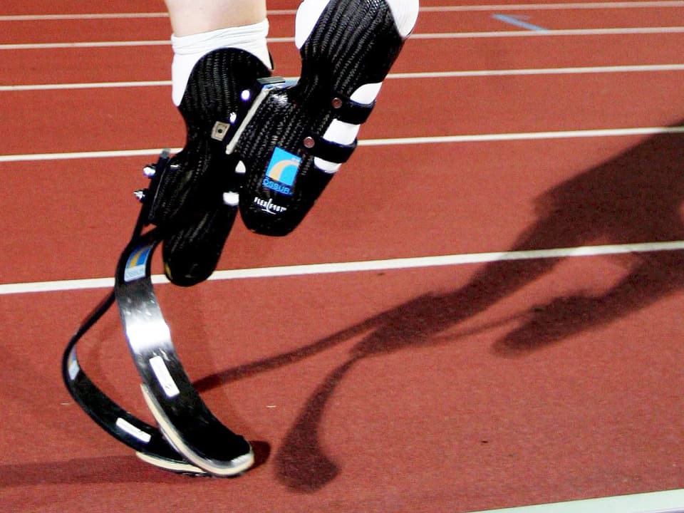 Sprinter mit speziellen Beinprothesen auf einer Tartanbahn.