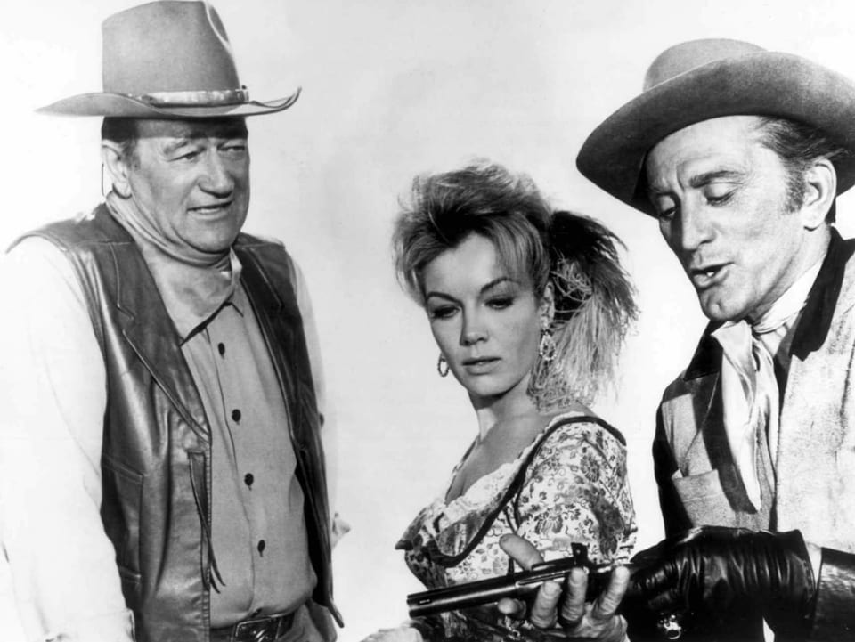 Johne Wayne, Joanna Barnes und Kirk Douglas