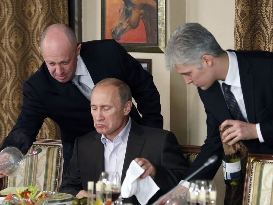 Yevgeny Prigozhin serviert Wladimir Putin eine Mahlzeit.