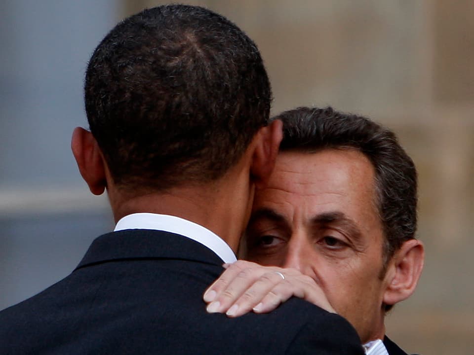 France's President Nicolas Sarkozy (R) hugs US Democratic presidential candidate Senator Barack Obama (D-IL) as they say goodbye at the Elysee Palace in Paris July 25, 2008.