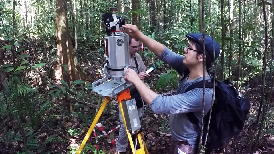 Zwei Männer hantieren mit Laser-Scanner im Wald.