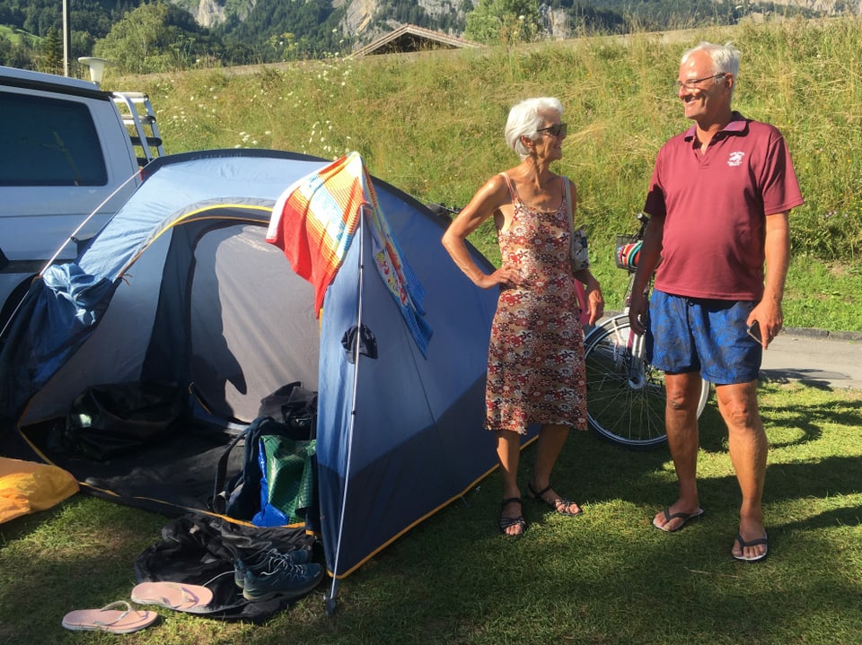 Ein Ehepaar vor einem kleinen Zelt.