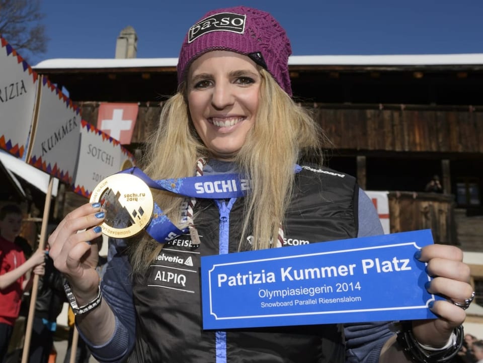 Patrizia Kummer wird gefeiert, sie hebt ihre Olympiamedaille in die Kamera