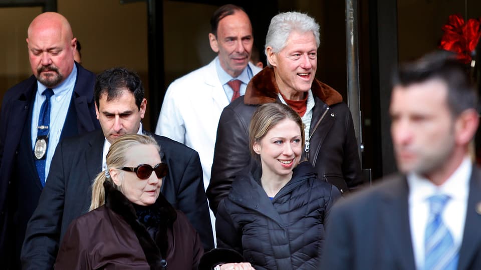 Hillary Clinton (mit Sonnenbrille) verlässt das Spital in Begleitung ihrer Tochter Chelsea und ihres Ehemannes Bill.