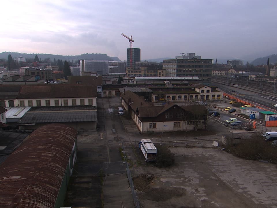 Parkplätze, Gleise, alte Gebäude von oben fotografiert.