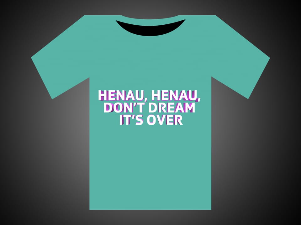 Weisse Schrift auf grünem T-Shirt: Henau, Henau, Don't Dream It's Over.