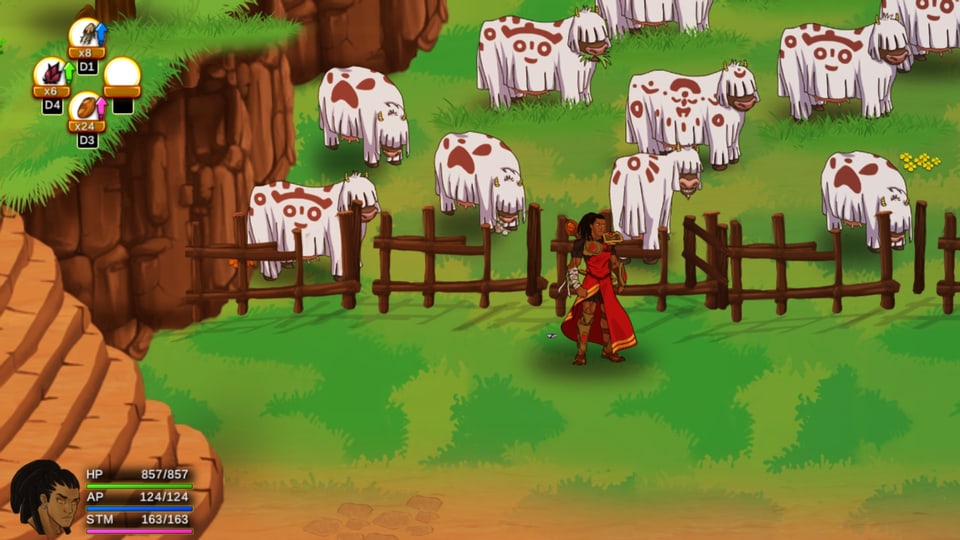 Kühe auf einer Weide in mit Symbolen bemalten weissen Umhängen.