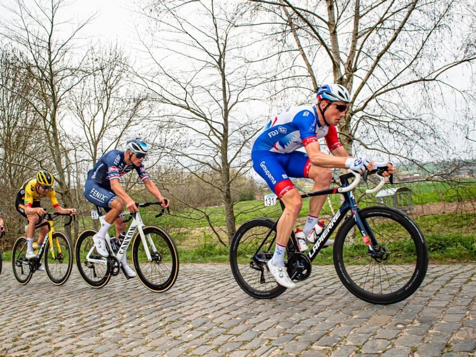 Mit dem späteren Sieger Mathieu van der Poel am Hinterrad Stefan Küng führt das Feld über eine Kopfsteinpflaster-Passage.