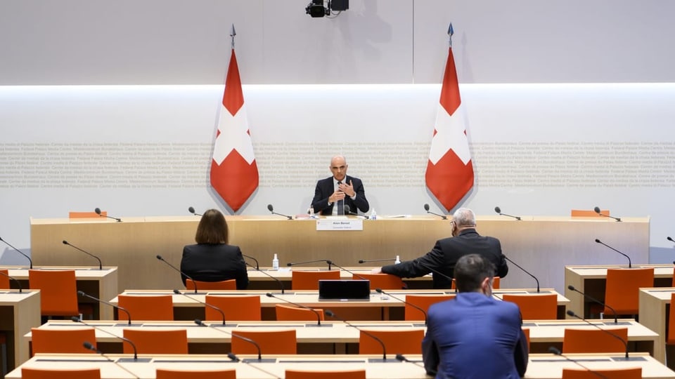 Alain Berset im Anzug sitzt hinter einem Rednerpult.