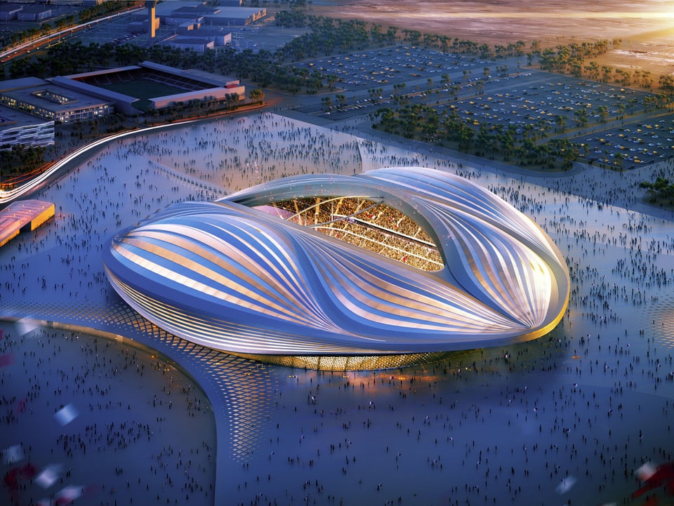 Ein futuristisch anmutendes, erleuchtetes Stadion in Blautönen, fotografiert aus Vogelperspektive.