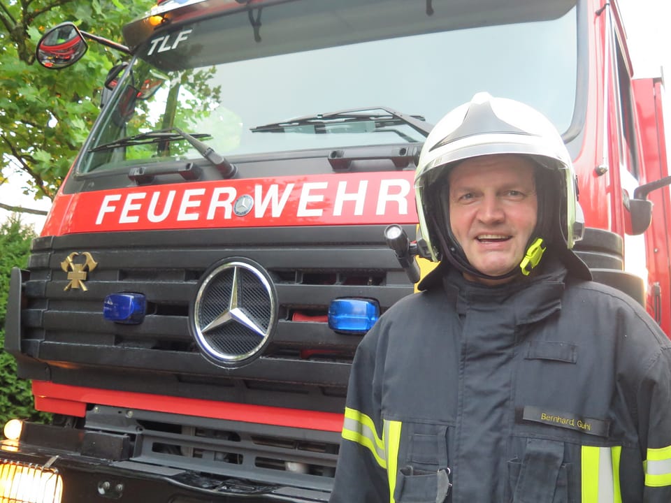 Bernhard Guhl steht vor einem Feuerwehrauto