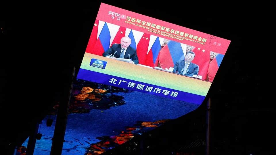 Ein Bildschirm, auf dem Wladimir Putin und Xi Jinping zu sehen sind. 