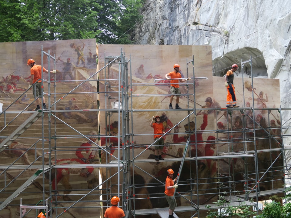 Ein riesiges historisches Gemälde wird vor dem Löwendenkmal in Luzern aufgebaut. 