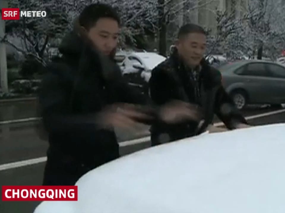 Zwei Männer halten die Hände in den Schnee.