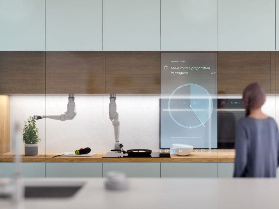 Visualisierung einer zukünftigen Küche mit Roboterarmen, die kochen.