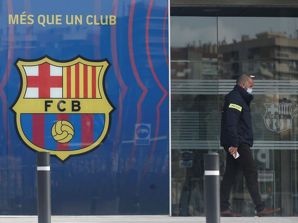 Ein Polizist verlässt die Geschäftsstelle des FC Barcelona nach der Razzia