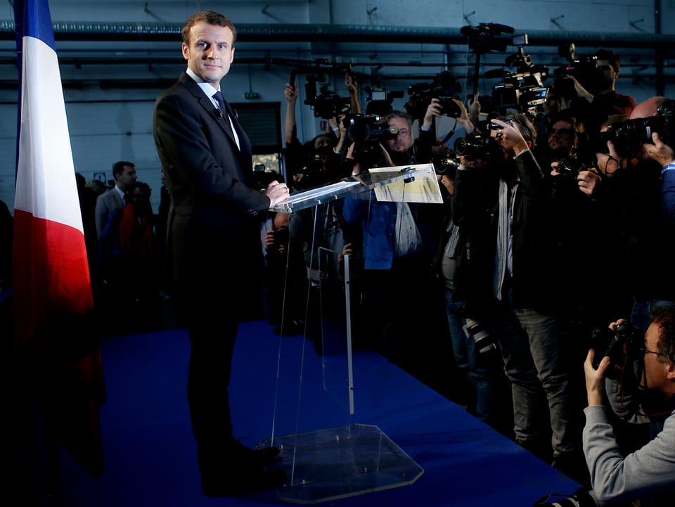 Emannuel Macron vor einer Rede auf dem Podium. 