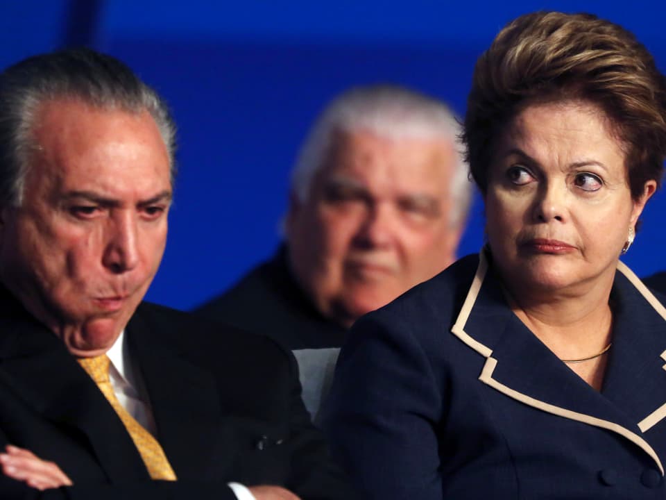 Dilma Rousseff sitzt neben einem schmollenden Michel Temer. 