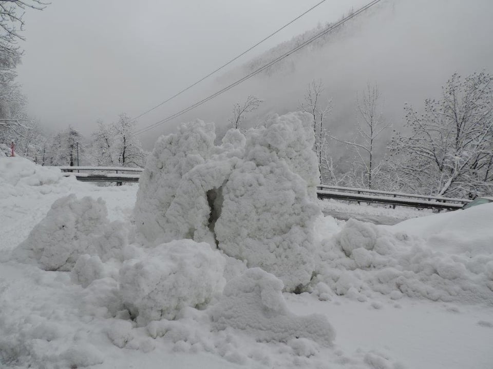 Aufgetürmte Schneemassen von der Lawine auf der Strasse ins Valle di Peccia.