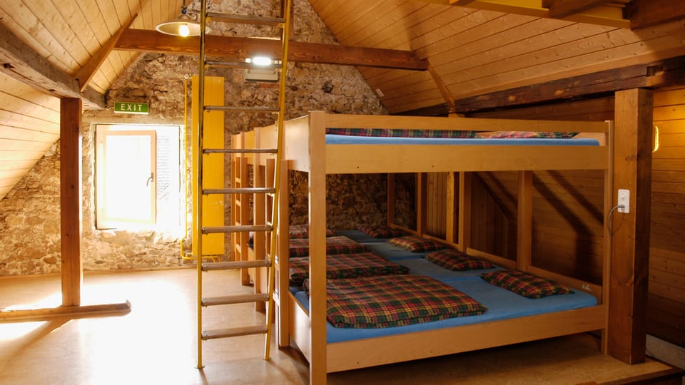 Ein Mehrbettzimmer mit Holzwänden.