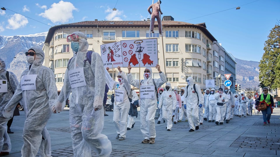 Demonstrationsteilnehmer in Schutzanzügen