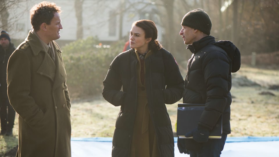Jason Clarke spricht mit Schauspielkollegin Keira Knightley und Regisseur James Kent auf dem Set.