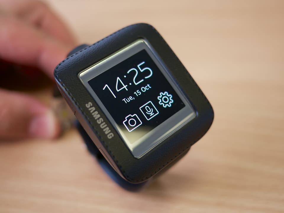 Rechteckige Smartwatch mit digitaler Zeitanzeige und einigen Symbolen.