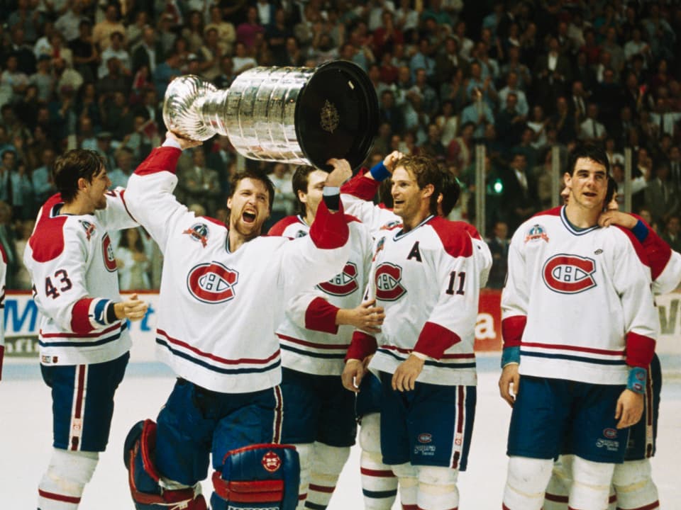Montreal Canadiens ice hockey players celebrate winning the Stanley Cup.