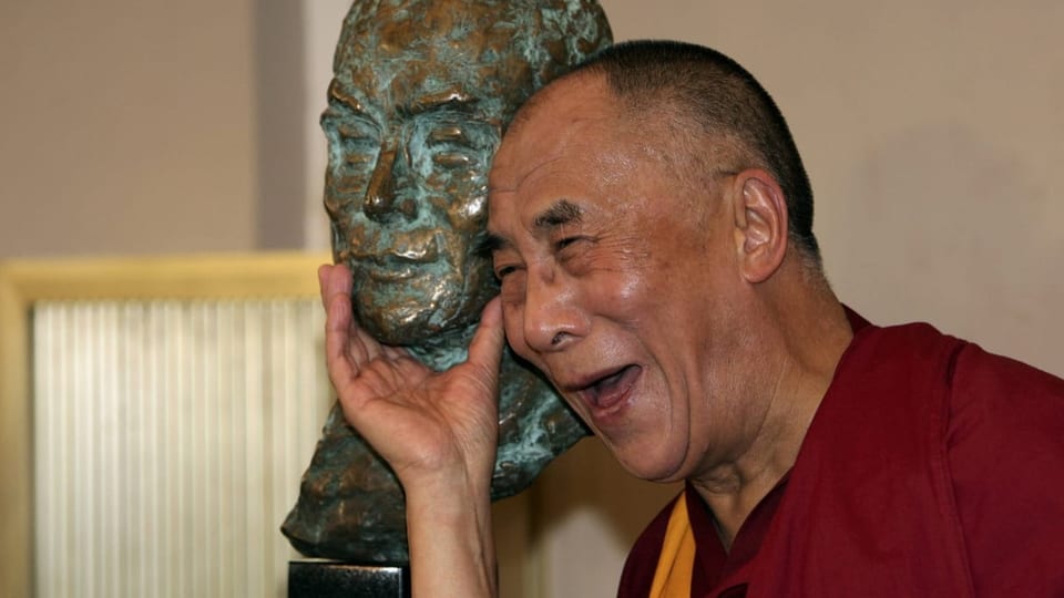 Dalai Lama mit einer Büste