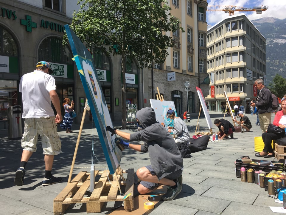 Verschiedene Künstler malen auf Leinwand auf dem Alexanderplatz