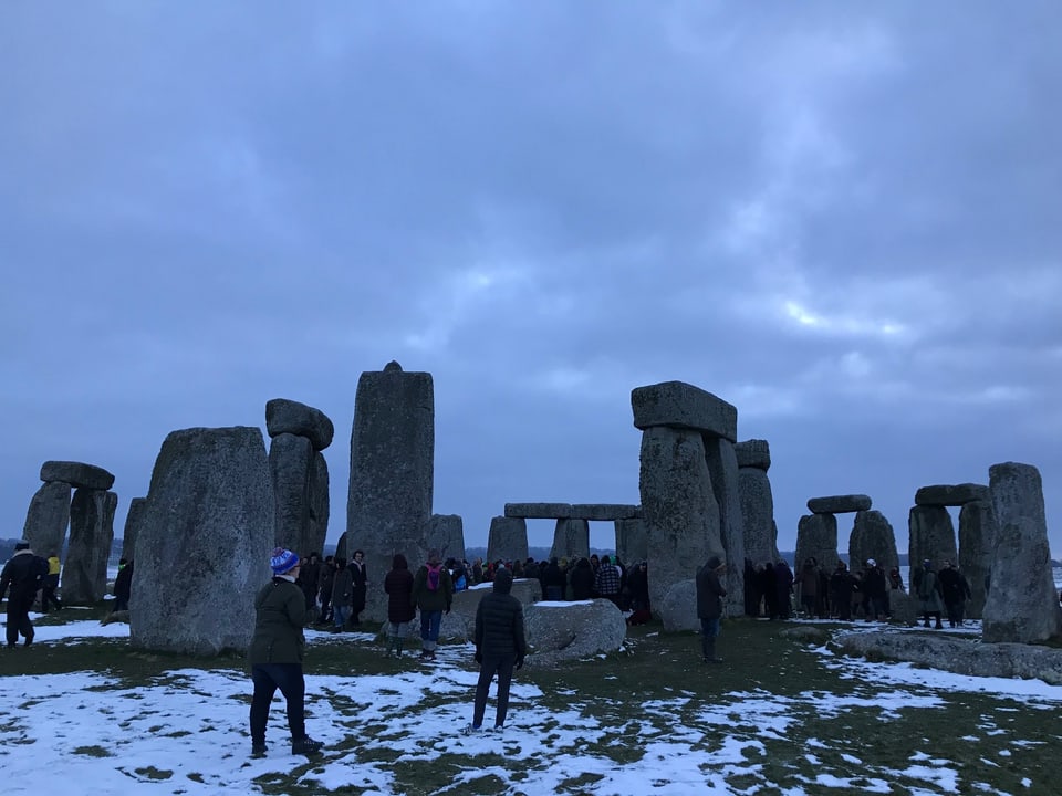 Touristen besichtigen Stonehenge.
