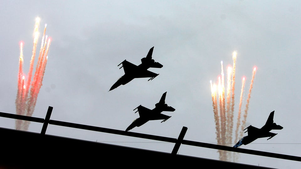 Drei US-Kampfjets über einem Feuerwerk in einem Stadion