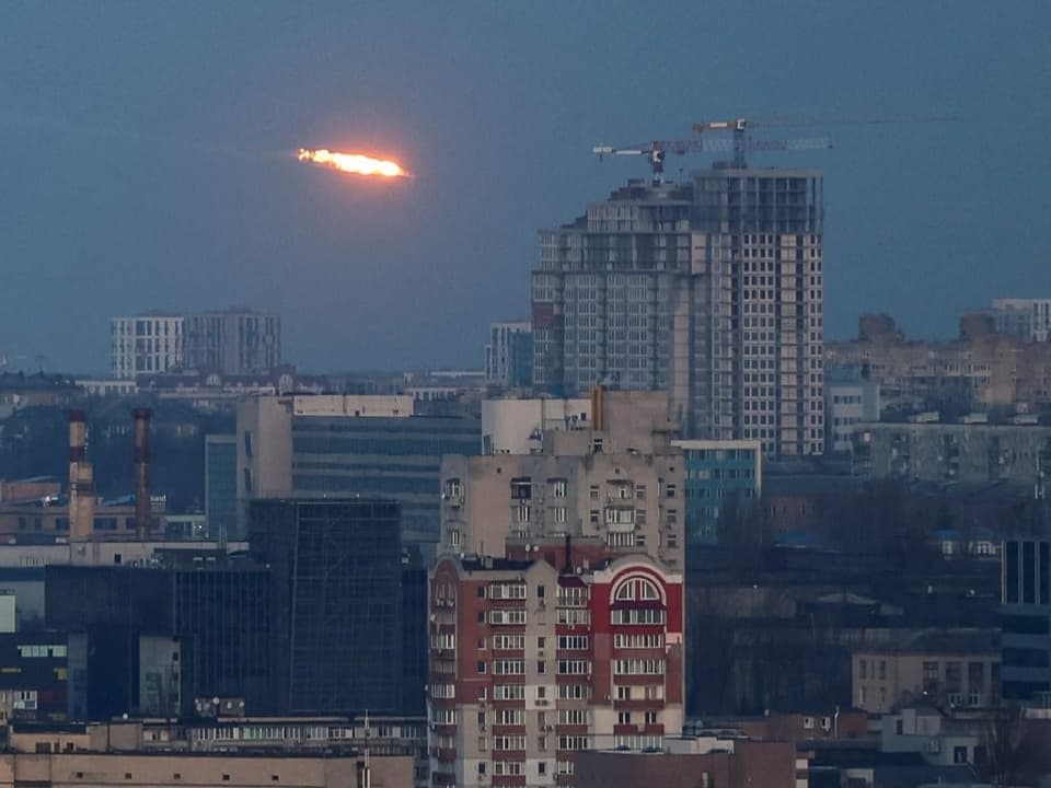 A missile flies over the Ukrainian capital in the dawn light.