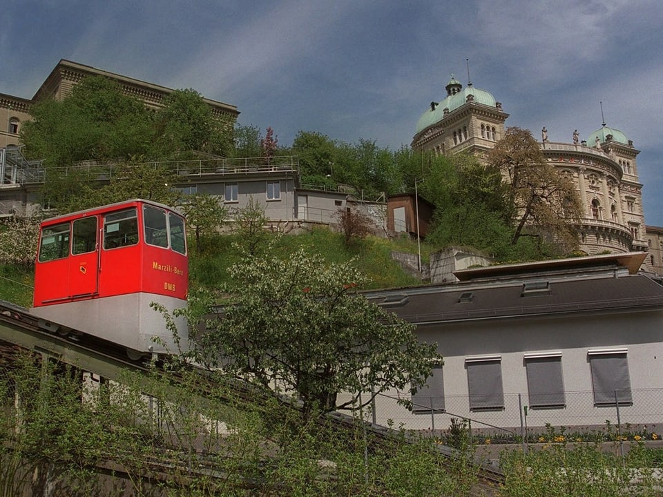 Das Bild zeigt eine kleine, rote Standseilbahn in Bern.