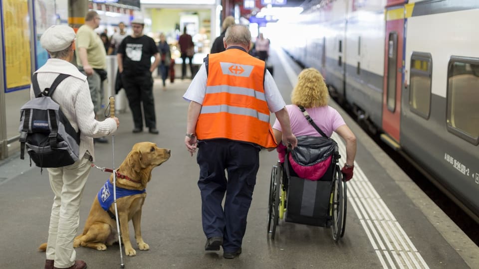 Frau mit Blindenhund und Frau im Rollstuhl