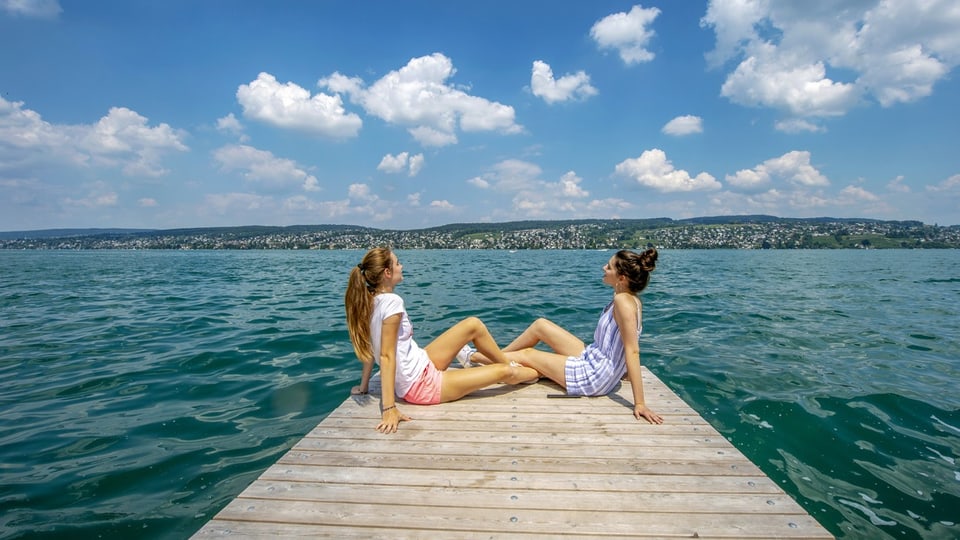 Zwei Frauen am Sonnenbaden am See.