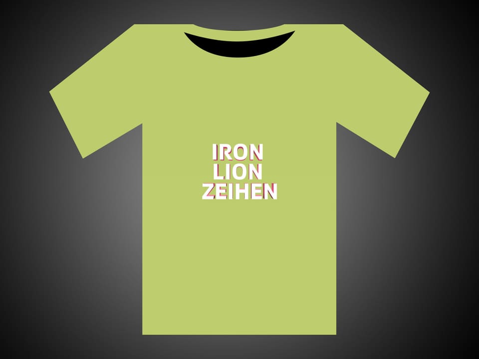 Weisse Schrift auf grünem T-Shirt: Iron Lion Zeihen.