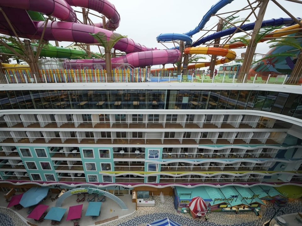 Über mehreren Stockwerken befinden sich mehrere farbige Wasserrutschen.