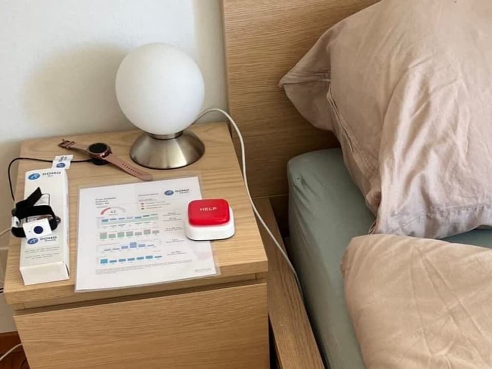 Bedside table with red button.
