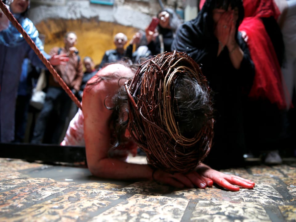 Ein Schauspieler, der Jesus spielt, liegt blutig auf dem Boden.