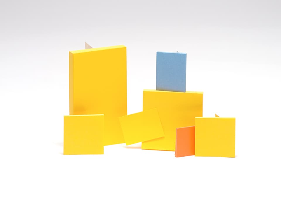 Fünf gelbe Post-it-Zettel, ein blaues und ein rotes. 