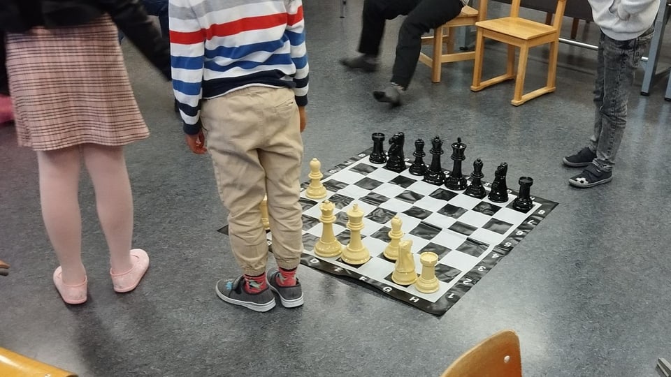 Kinder um Schachbrett