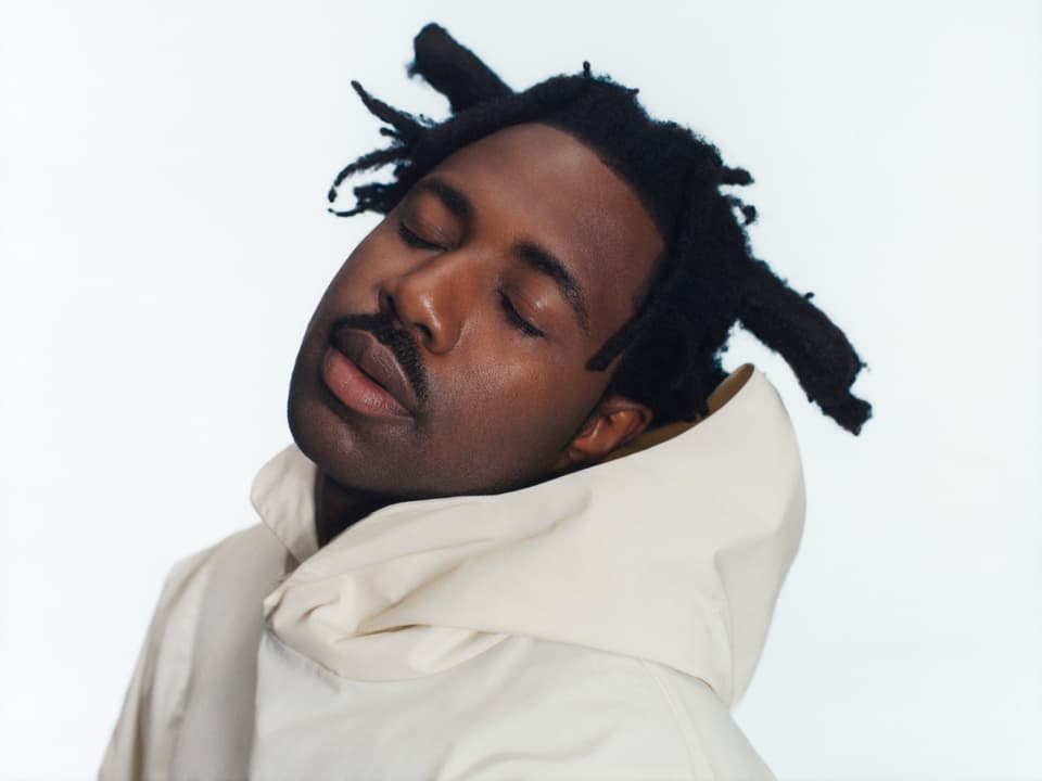a black musician with a white hoodie.
